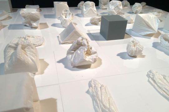 Image of small 3D-printed cubes and collapsed cube shapes